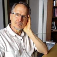 Photograph of Tim Raser at desk