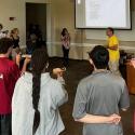 Students in a circle playing coco